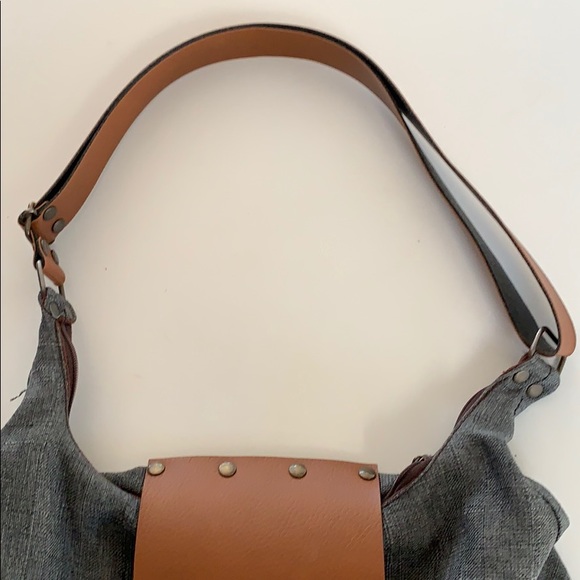 Leather strap and front clasp. Zippers shut. - Picture 3 of 5